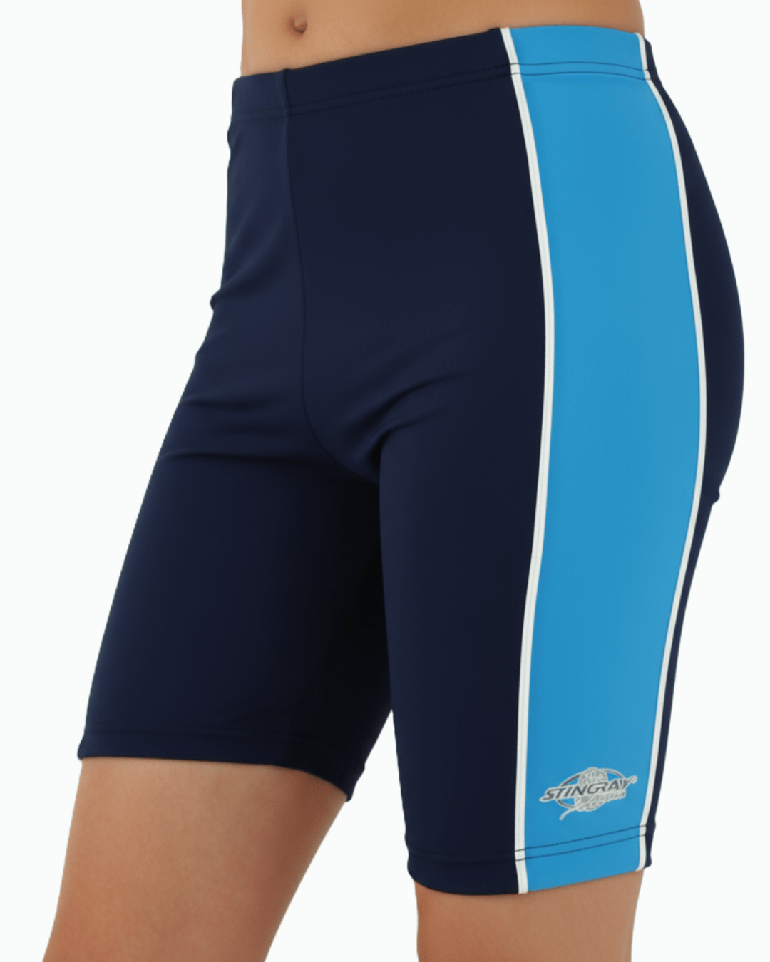 Toddler wearing navy and azure UV swim shorts with a Stingray logo on a white background