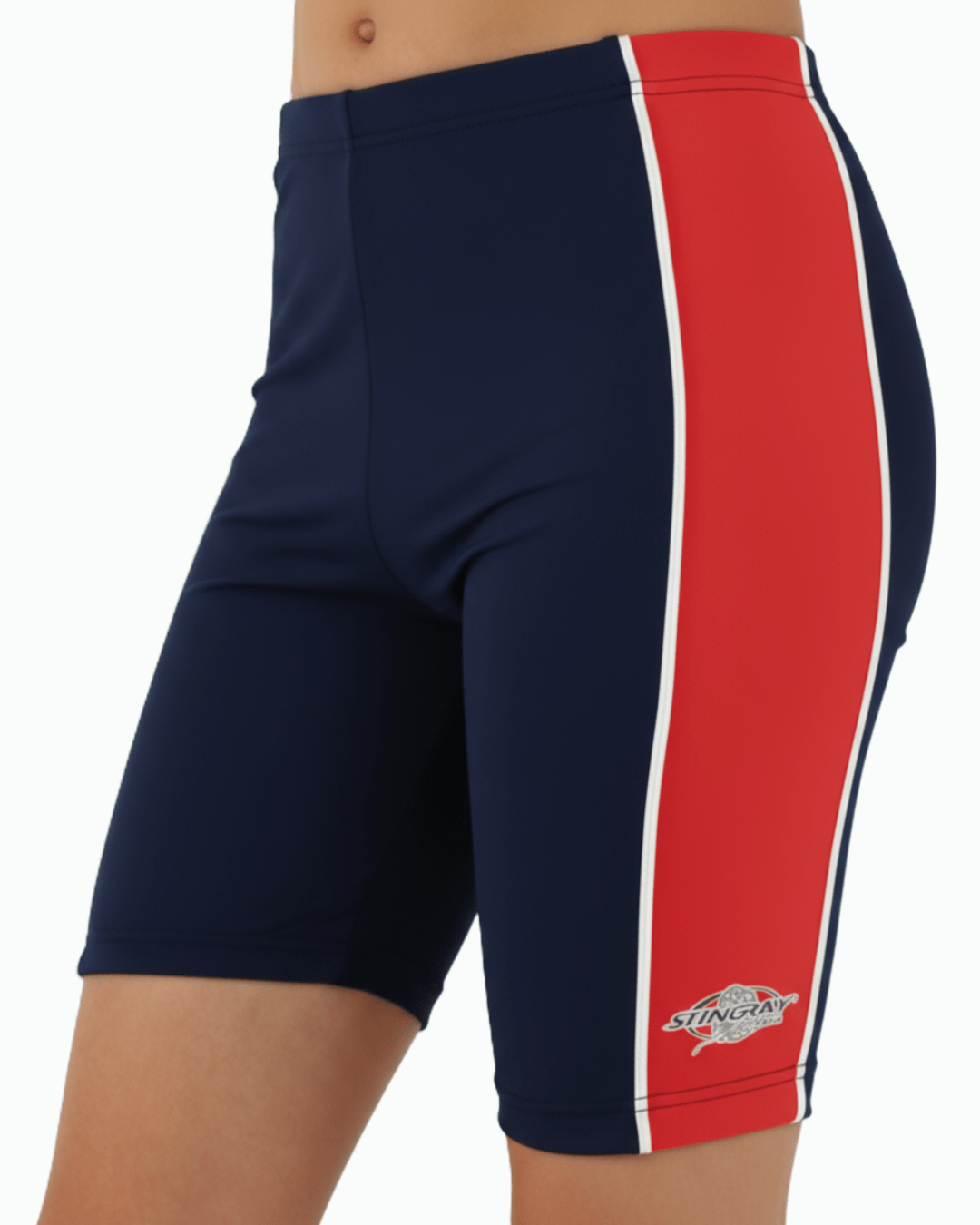 Toddler wearing navy upf swimming trunks with a red stripe and a Stingray logo on a white background