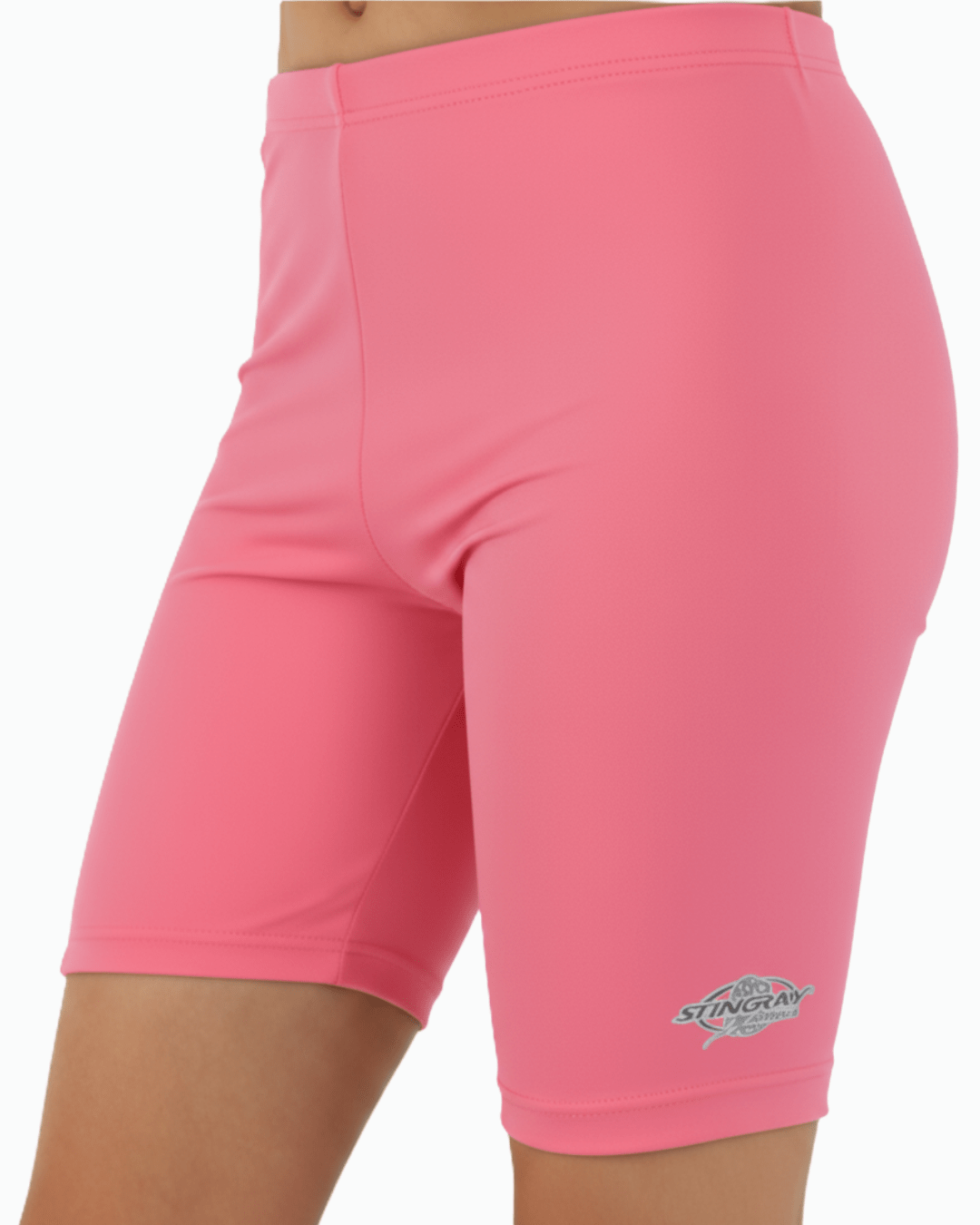 Toddler wearing pink UV protection swim trunks with a Stingray logo on a white background