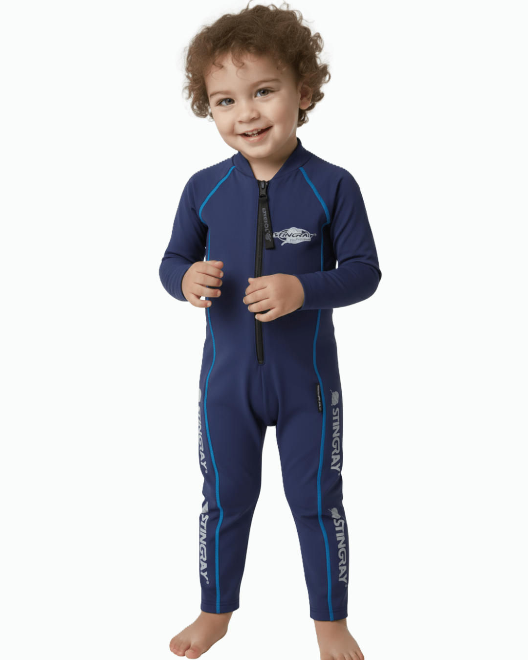 Toddler wearing an all in one navy blue sunsuit with Stingray logo on a white background
