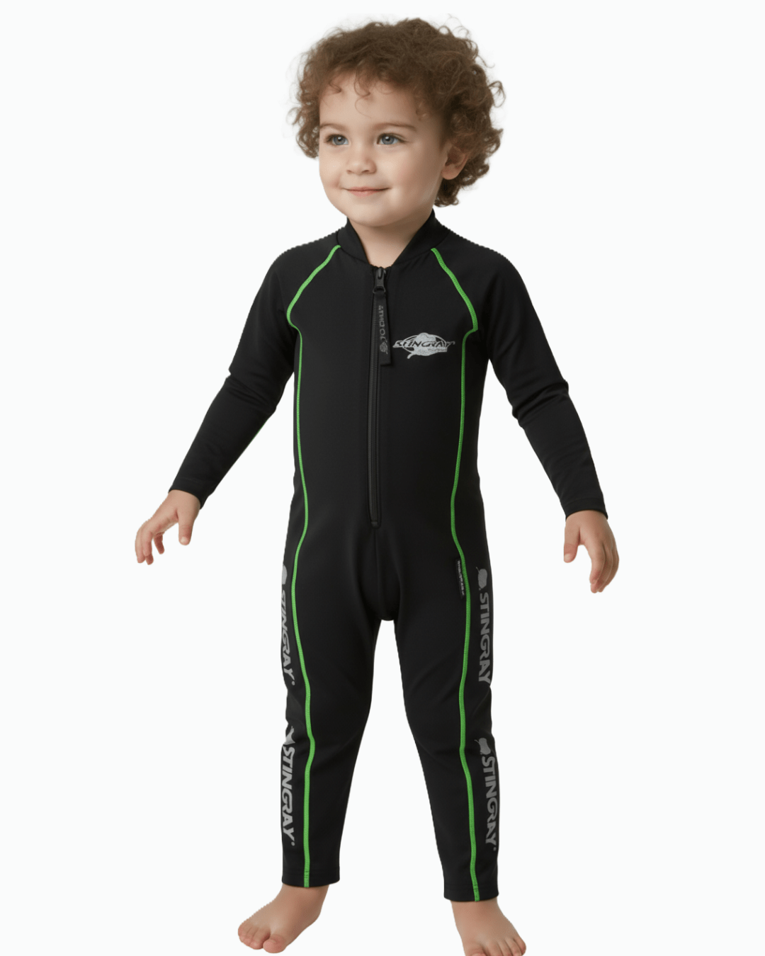 Toddler wearing a black UV sunsuit with green flatlock stitching on a white background