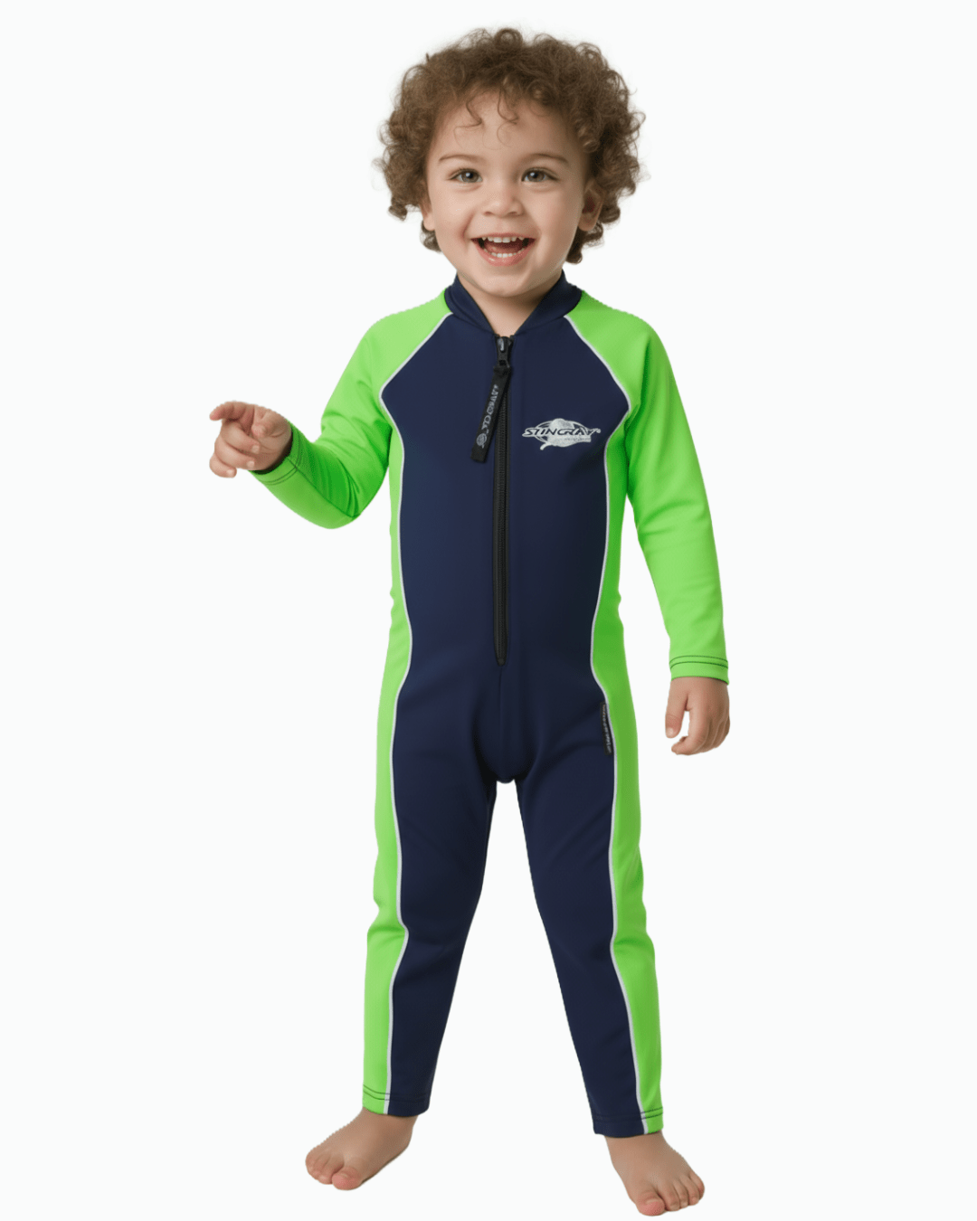 Toddler wearing a navy and green all in one UV protection swimsuit on a white background