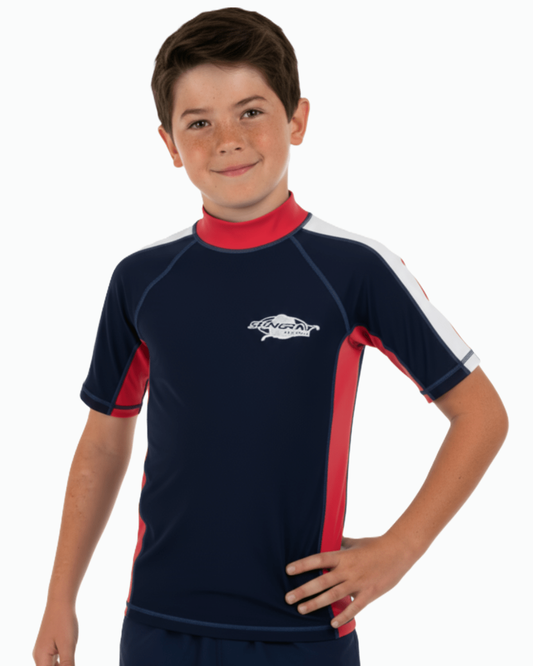 Boy wearing a navy and red upf 50+ rash shirt with a Stingray logo on a white background