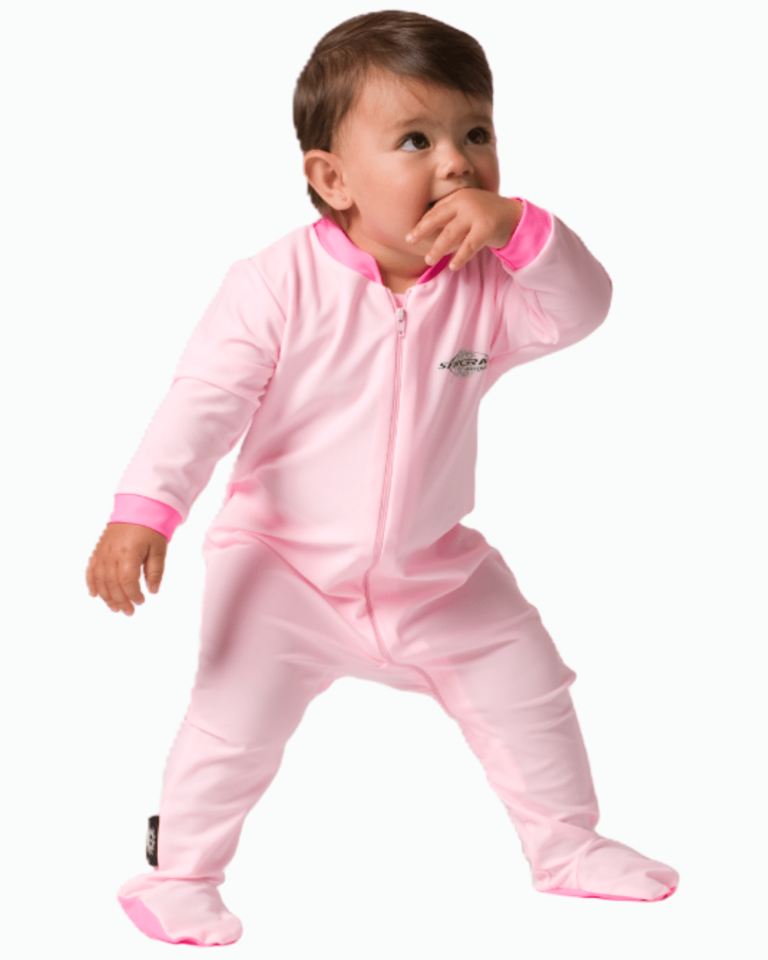 Baby in a pink UV full-body romper with a zipper on a white background