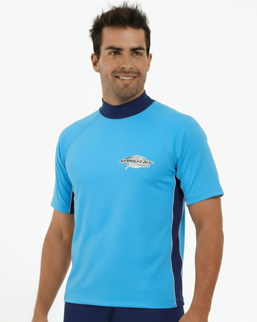 Man wearing azure and navy Stingray adult short sleeve rash shirt with UPF 50+ sun protection, made from chlorine-resistant fabric for outdoor and water activities.