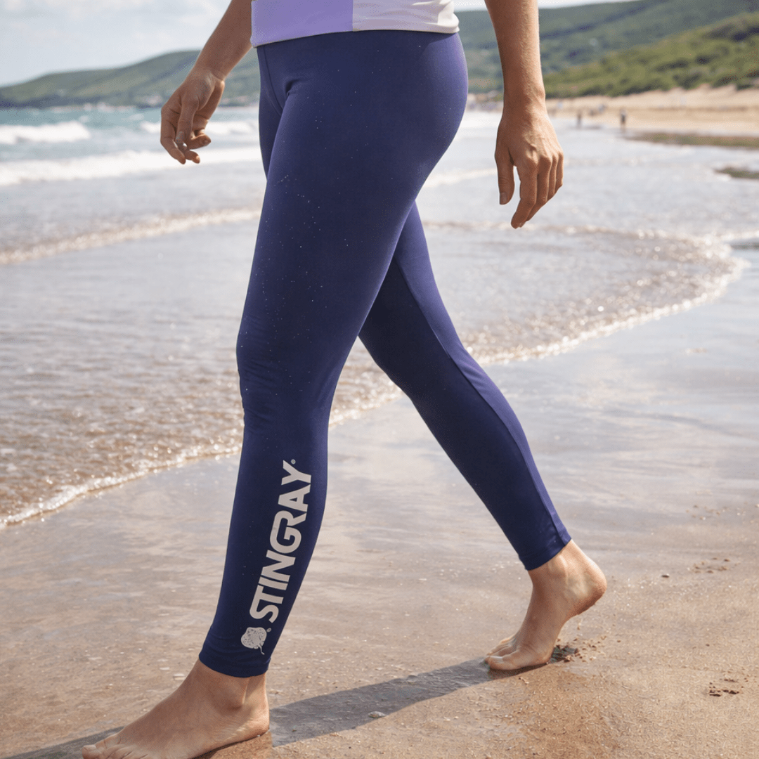Woman wearing UPF 50+ swim leggings on the beach