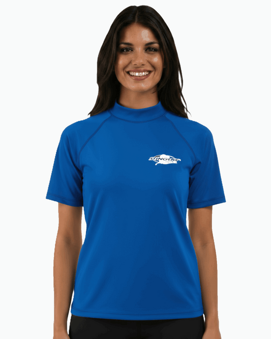 Woman wearing an ocean blue Stingray adult short sleeve rash shirt with UPF 50+ UV protection, made from chlorine-resistant fabric for outdoor and water activities.