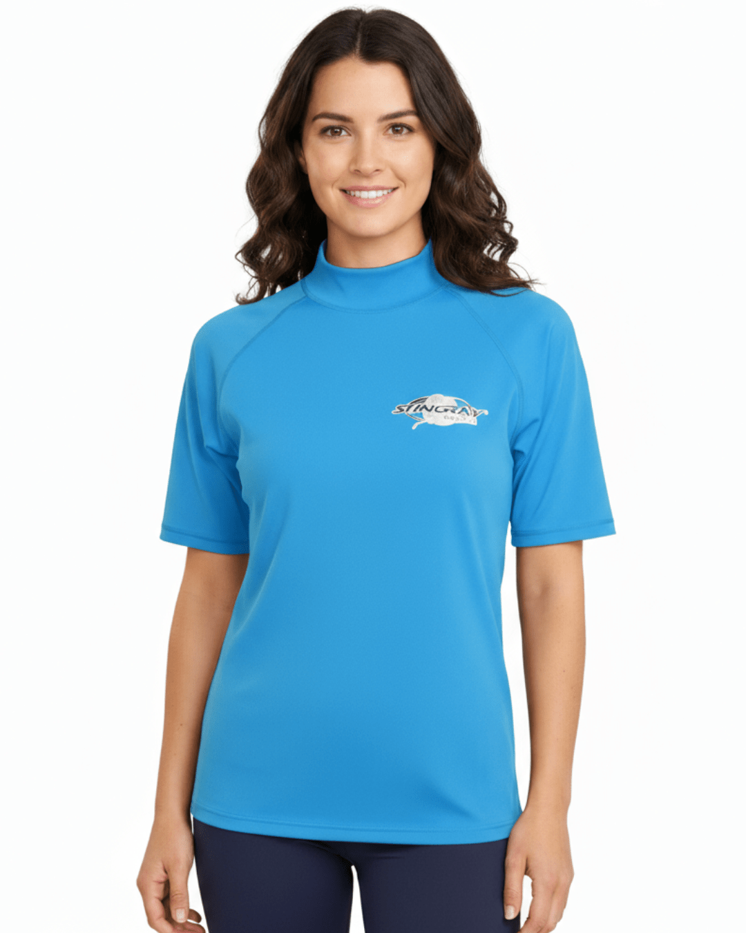 Woman wearing azure Stingray adult short sleeve rash shirt with UPF 50+ sun protection, made from chlorine-resistant fabric for outdoor and water activities.