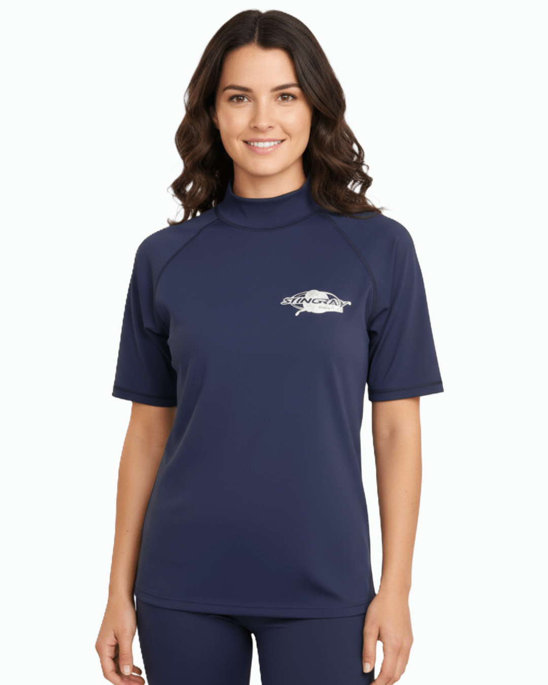Woman wearing navy Stingray adult short sleeve rash shirt with UPF 50+ sun protection, made from chlorine-resistant fabric for outdoor and water activities.