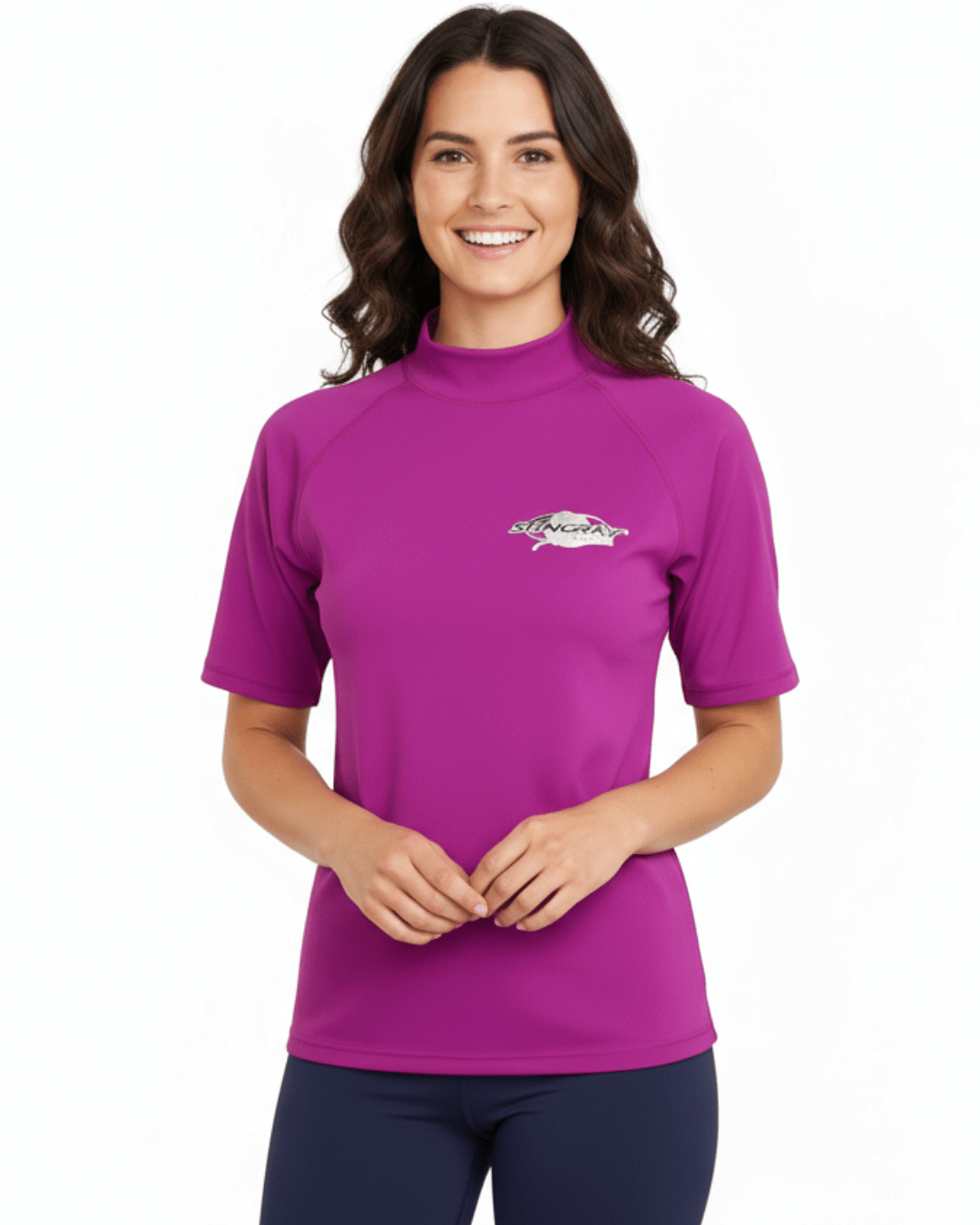 Woman wearing purple Stingray adult short sleeve rash shirt with UPF 50+ sun protection, made from chlorine-resistant fabric for outdoor and water activities.