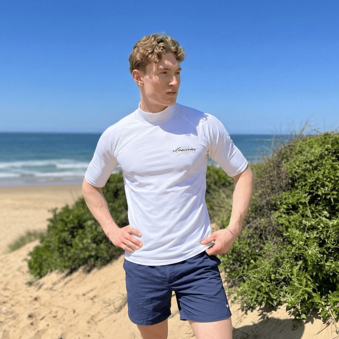 Man wearing a short sleeve UV swim shirt on the beach 