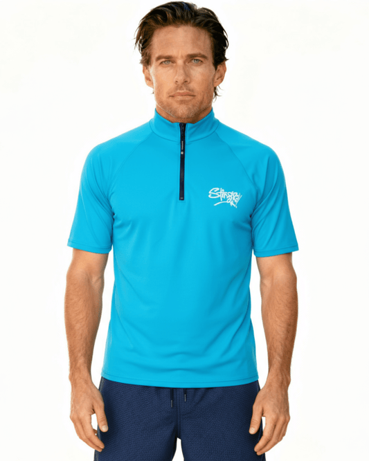 Man wearing blue Stingray unisex adult short sleeve quarter zip rash shirt with UPF 50+ sun protection.