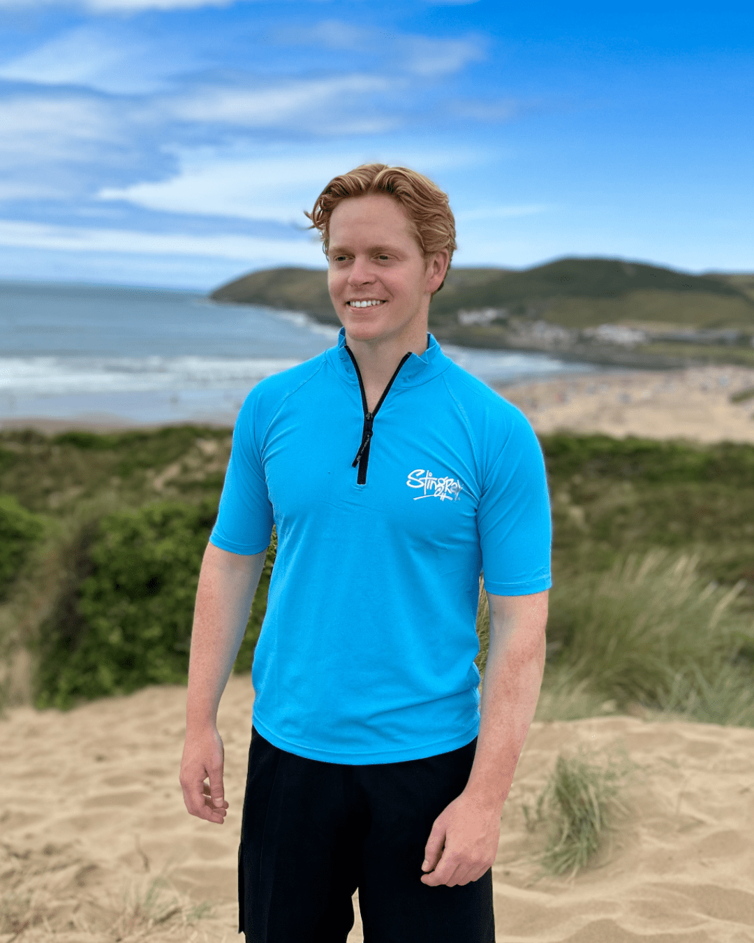 Man wearing the azure UPF 50+ zipped rash shirt on the sand dunes