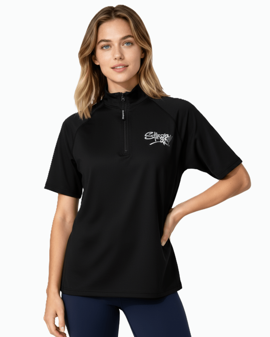 Woman wearing black Stingray unisex adult short sleeve quarter zip rash shirt with UPF 50+ sun protection.