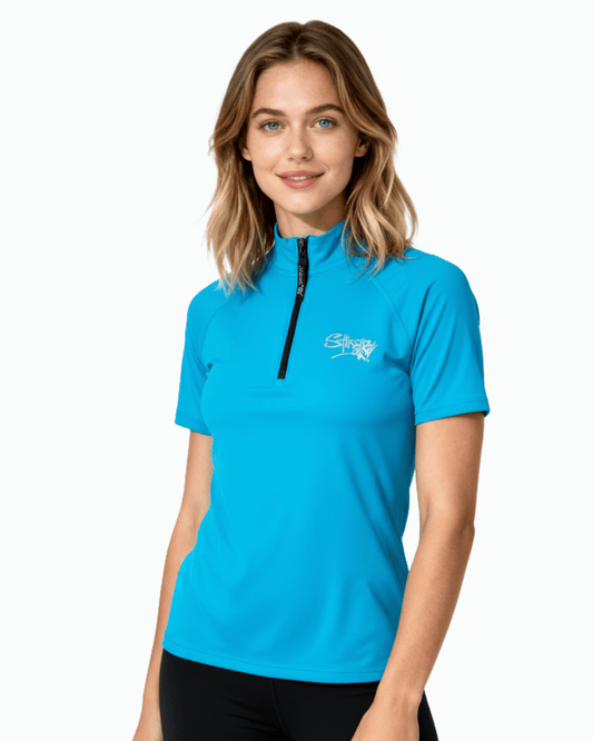 Woman wearing blue Stingray unisex adult short sleeve quarter zip rash shirt with UPF 50+ sun protection.