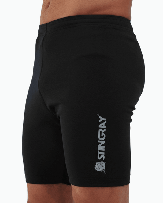 Man wearing black UPF 50+ swim shorts with Stingray logo on a white background