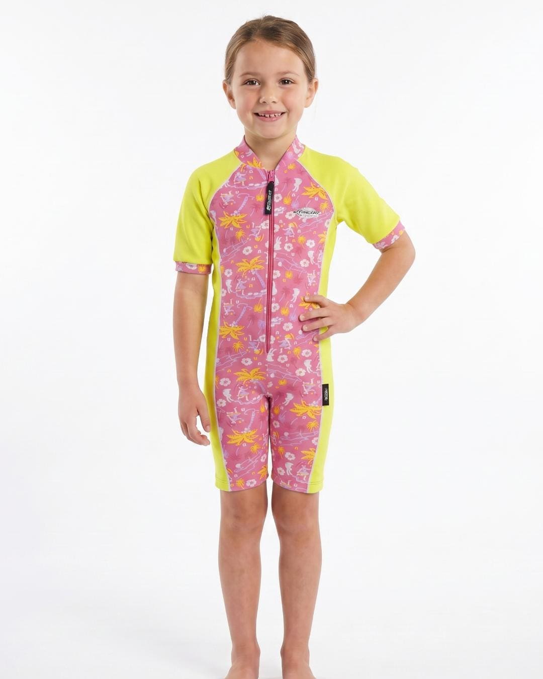 Child wearing a pink and yellow short sleeve UV swimsuit with floral patterns on a white background