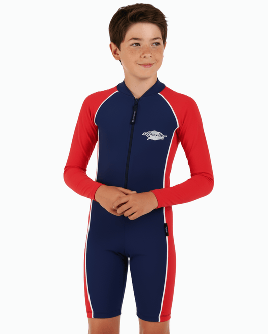 Boy wearing a red and blue navy UPF 50+ swimsuit on a white background