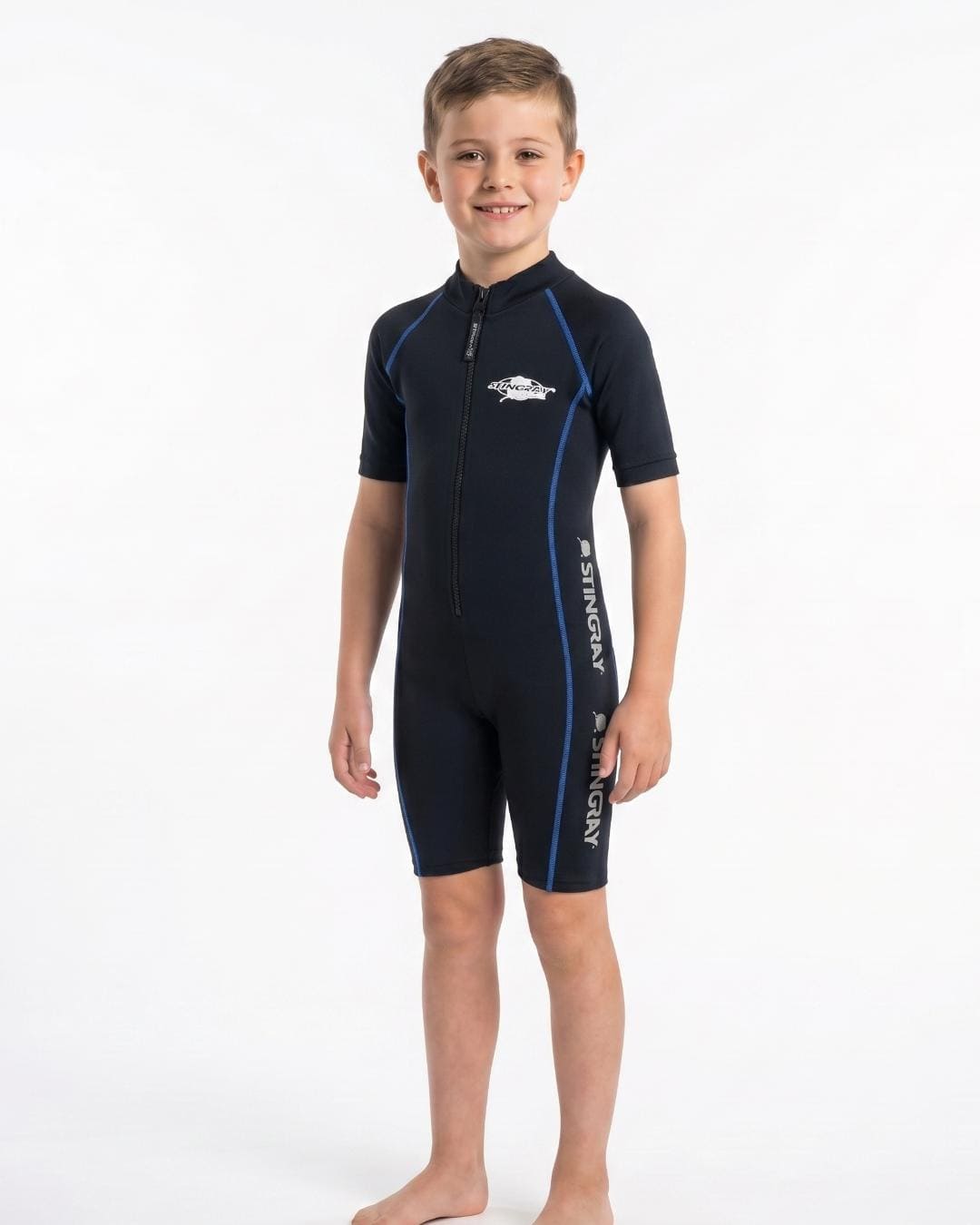 8 year old boy wearing a black short sleeve uv sunsuit on a white background