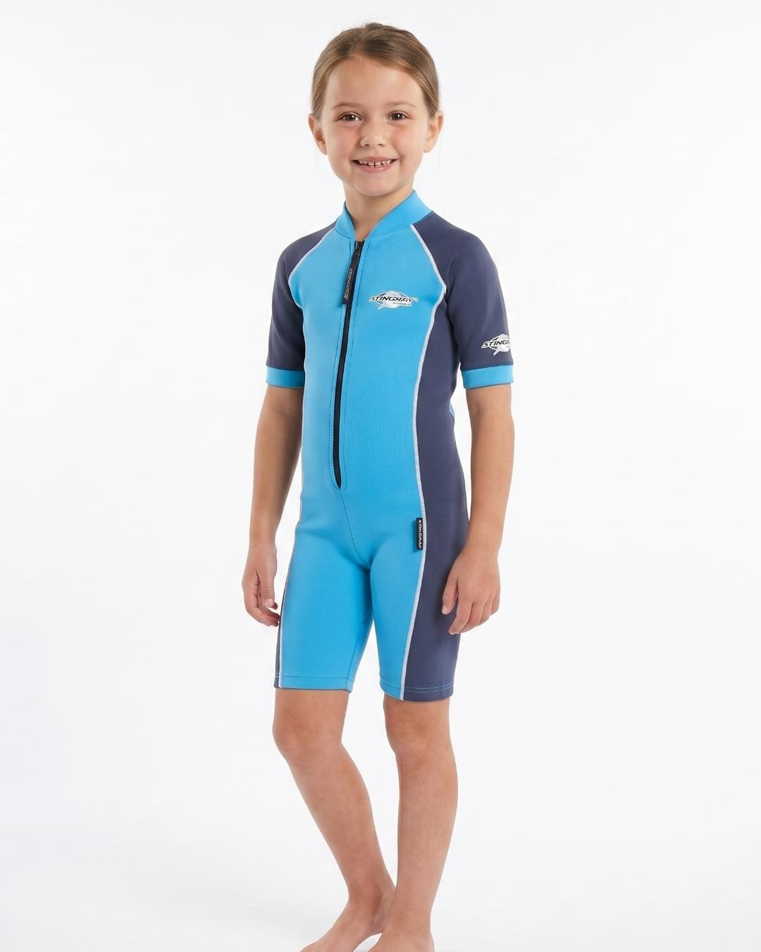 Girl wearing a blue and navy short sleeve uv swimsuit on a white background