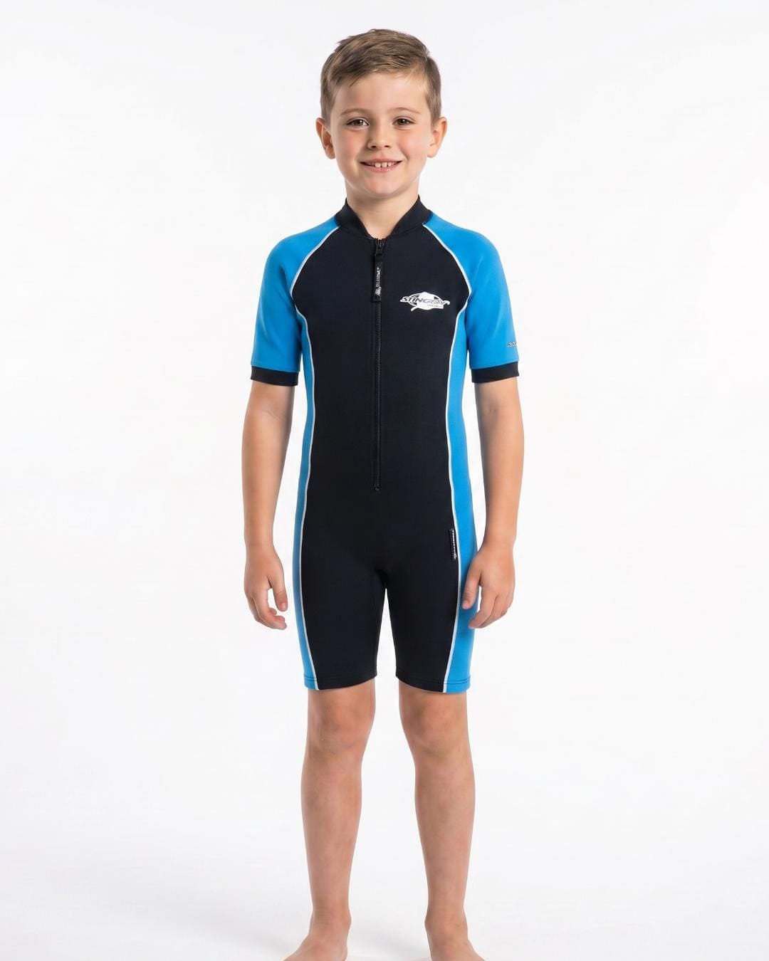 Boy wearing a black and blue UPF short sleeve swimsuit on a white background