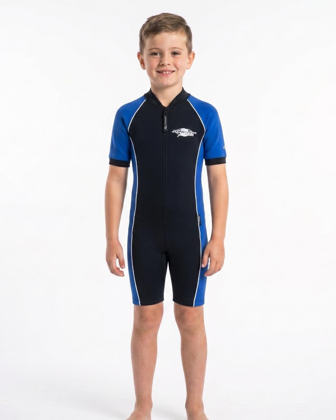 8 year old boy wearing a black and ocean blue short sleeve UV swimsuit on a white background