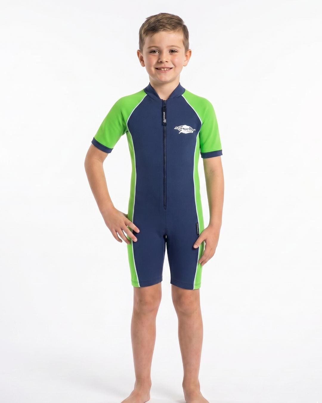 Boy wearing a navy and green short sleeve UV swimsuit on a white background