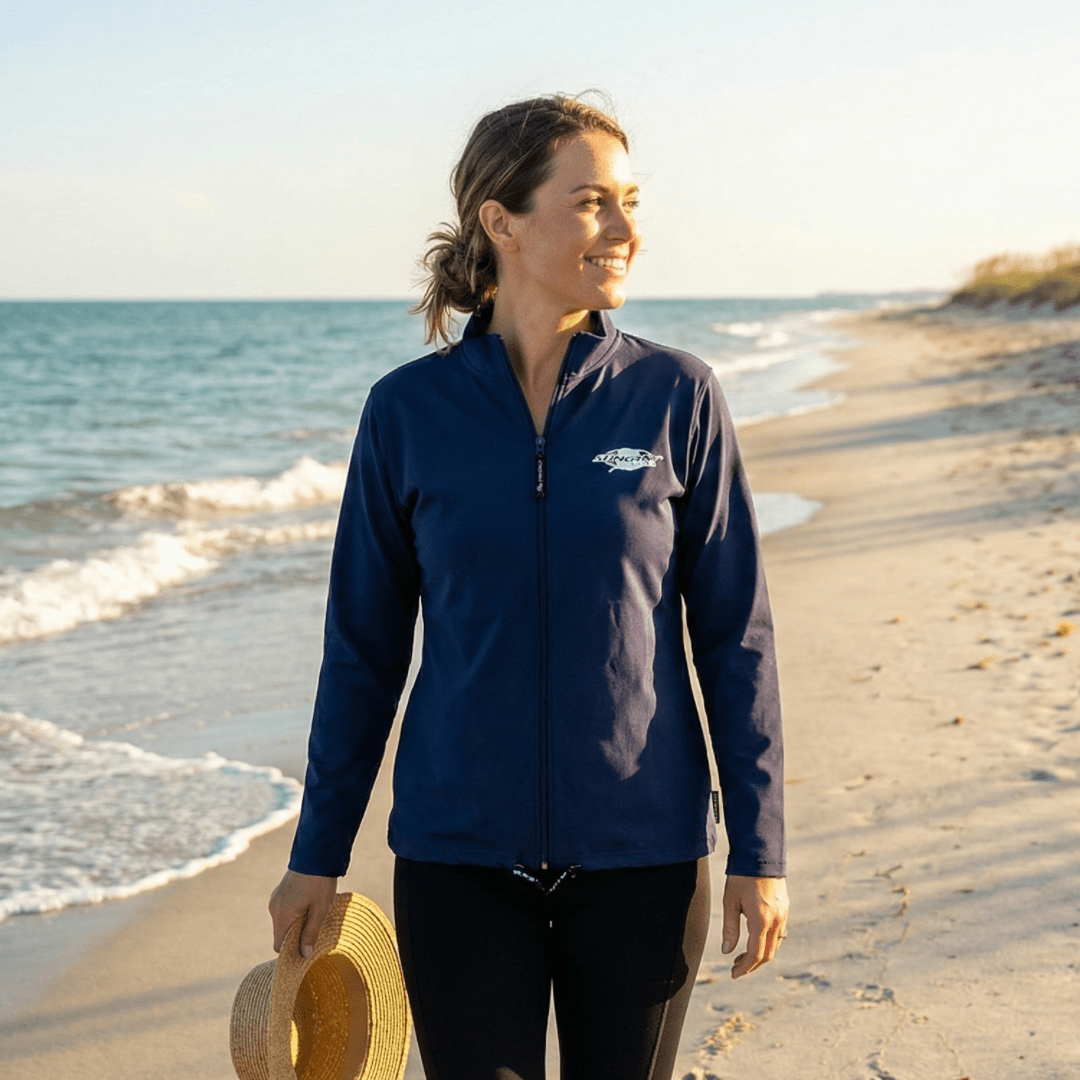 Woman wearing a navy UPF jacket on the beach