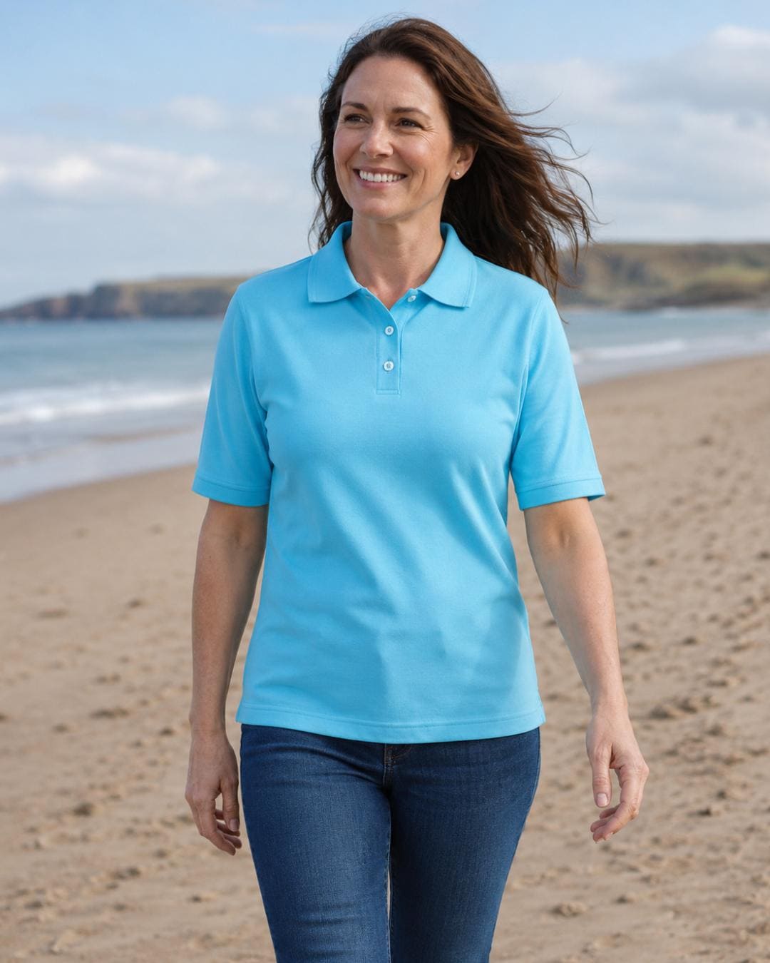 Lifestyle image of a woman wearing a ice blue short sleeve UV polo shirt and jeans on a white background