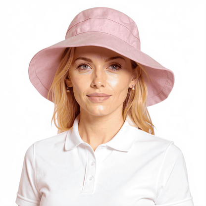 Model wearing light pink Stingray Women's Sun Hat with 4-inch wide brim and UPF 50+ sun protection. Fully-lined 100% cotton wide-brimmed sun hat with adjustable interior drawstring.