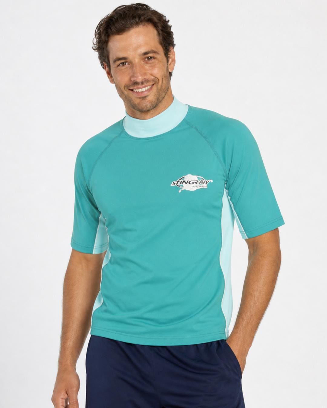 Man wearing teal and aqua UV rash shirt UPF 50+ in a white studio