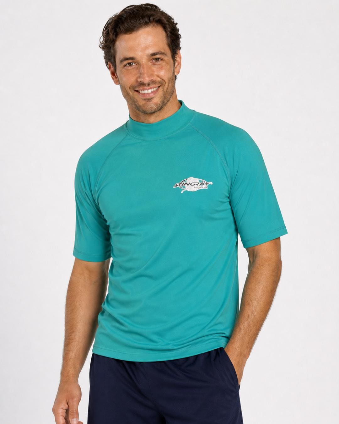Man wearing teal UV rash vest UPF 50+ in a white studio