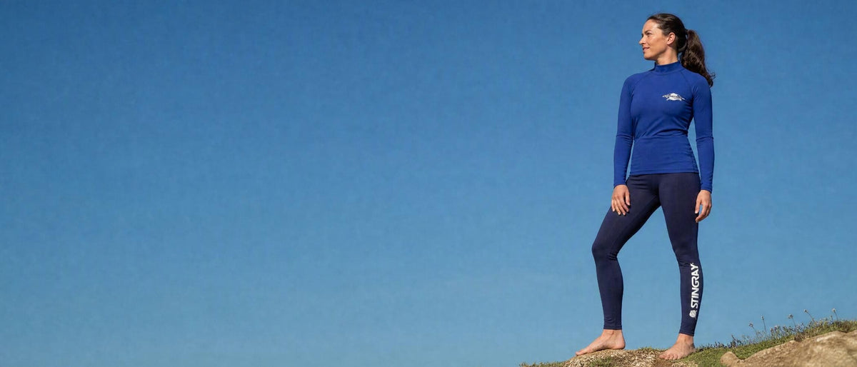 Woman in UPF 50+ swim leggings on sand dunes