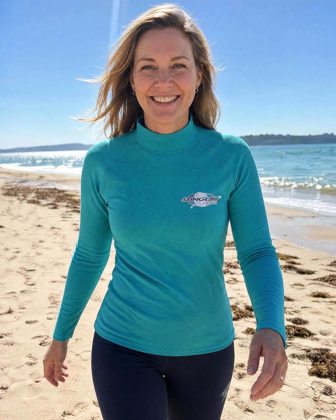 Woman wearing long sleeve UV swim shirt UPF 50+ on the beach
