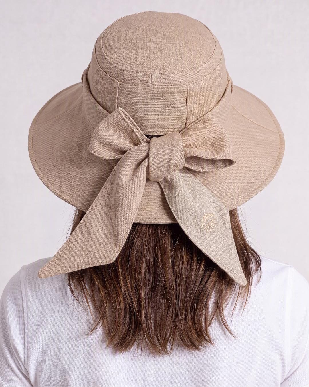Womens Reversible UV Wide Brim Sun Hat UPF 50+ Desert Sand on Outside and Oatmeal on inside  Ribbon Desert Sand - Close-up of the back on model