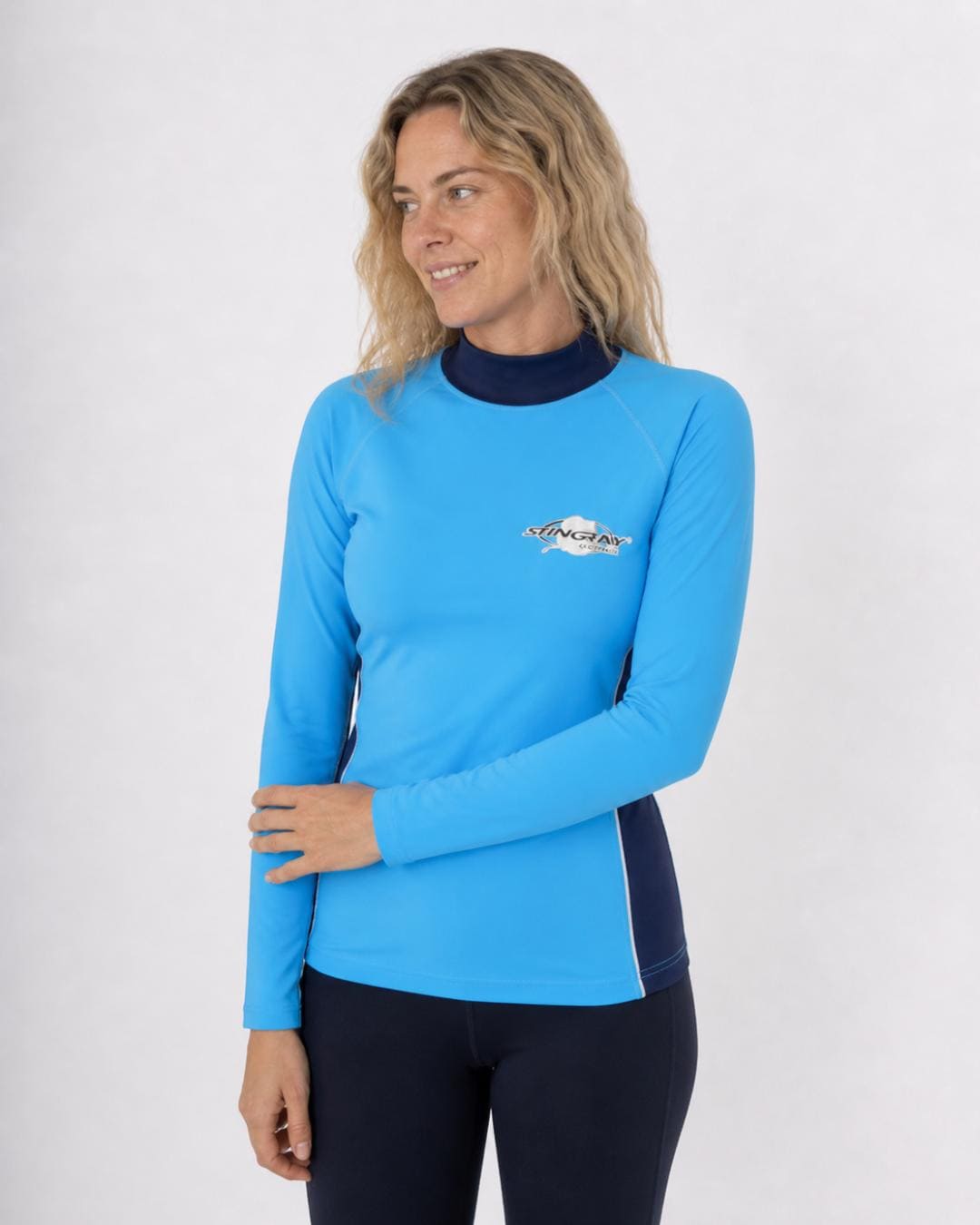 Woman wearing an azure and ocean blue long-sleeve UV swim shirt UPF 50+ on a white background