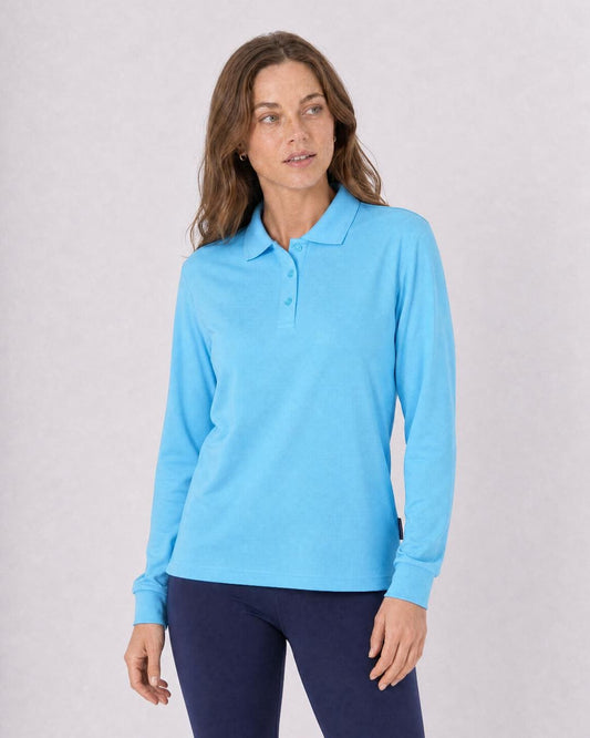 Woman wearing a light blue long-sleeve UV polo shirt UPF 50+ against a plain background