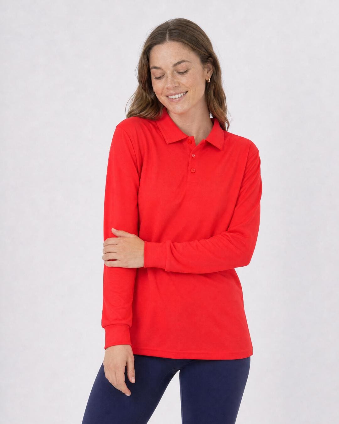 Woman wearing a red long-sleeve UV polo shirt UPF 50+ against a plain background