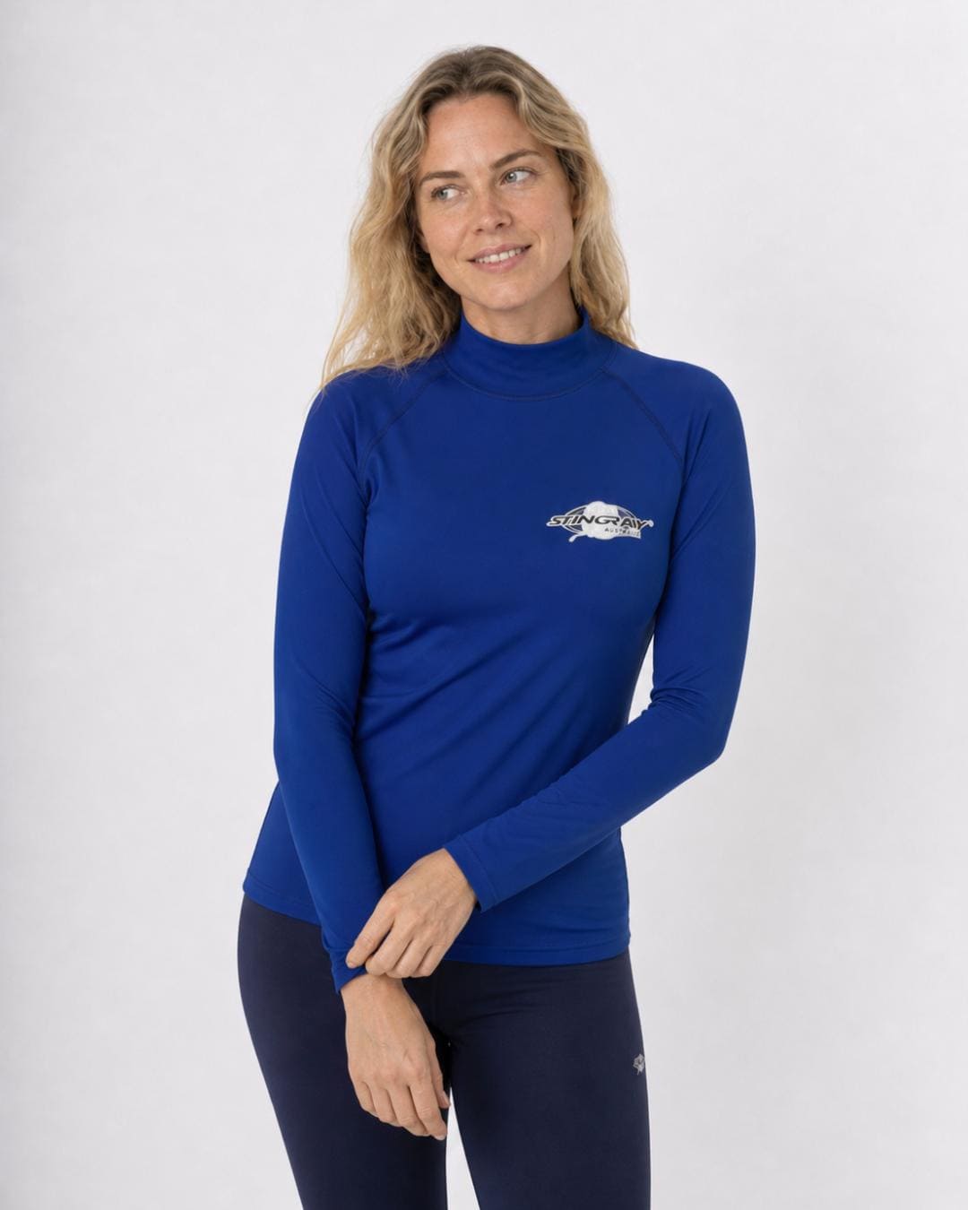 Woman wearing a ocean blue long-sleeve UV swim shirt UPF 50+ on a white background