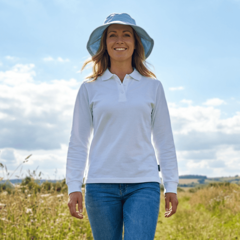 Woman wearing a UPF 50+ polo shirt in a field 