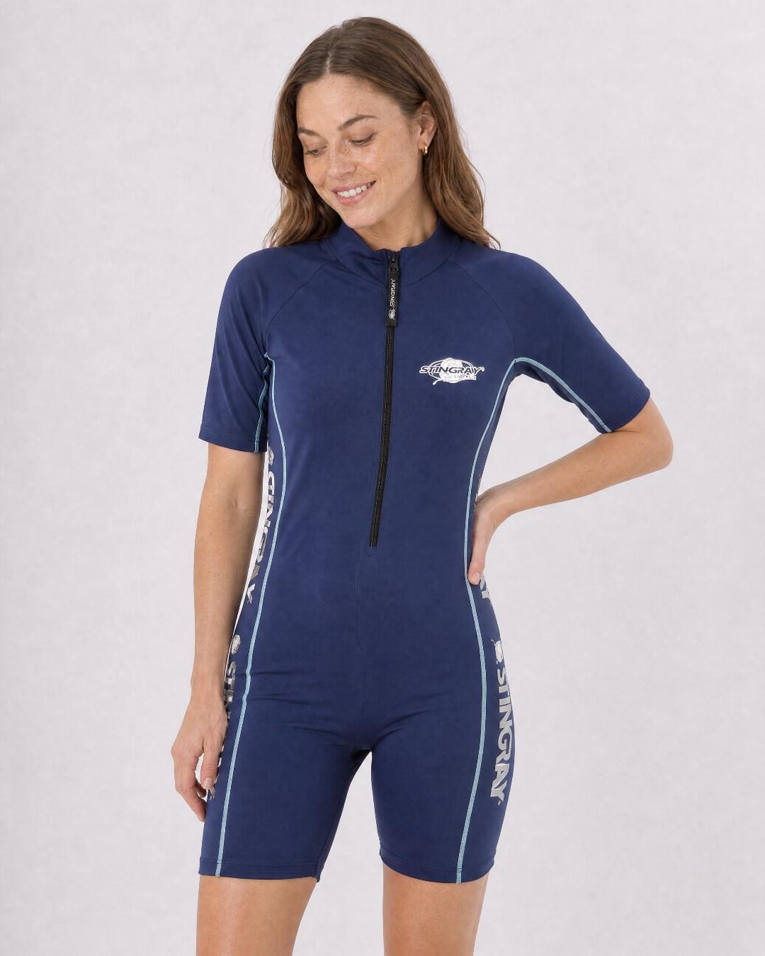 Woman wearing a navy full body UV swimsuit UPF 50+ on a grey background