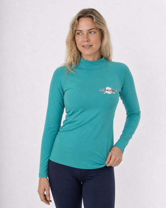 Woman wearing a teal long-sleeve UV swim shirt UPF 50+ on a white background
